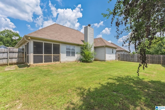 back of property featuring a lawn