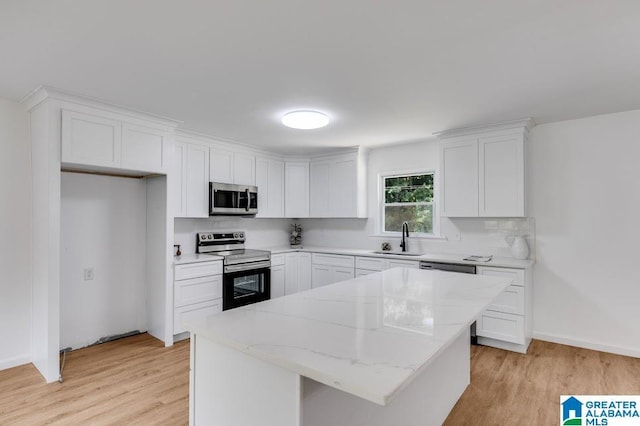 820 Boozer Rd, Heflin, AL 36264 - kitchen featuring appliances with stainless steel finishes, a sink, light wood-type flooring, and white cabinets
