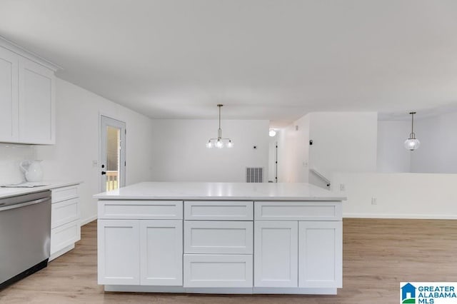 820 Boozer Rd, Heflin, AL 36264 - kitchen with dishwasher, light wood-style flooring, white cabinets, and hanging light fixtures