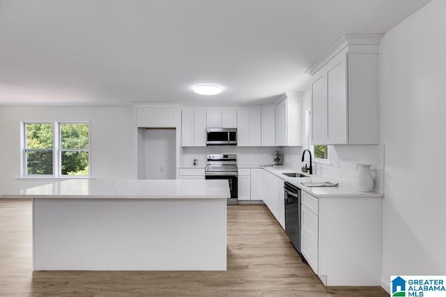 820 Boozer Rd, Heflin, AL 36264 - kitchen with stainless steel appliances, a sink, and white cabinets