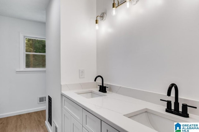 820 Boozer Rd, Heflin, AL 36264 - full bath with wood finished floors, baseboards, and double vanity