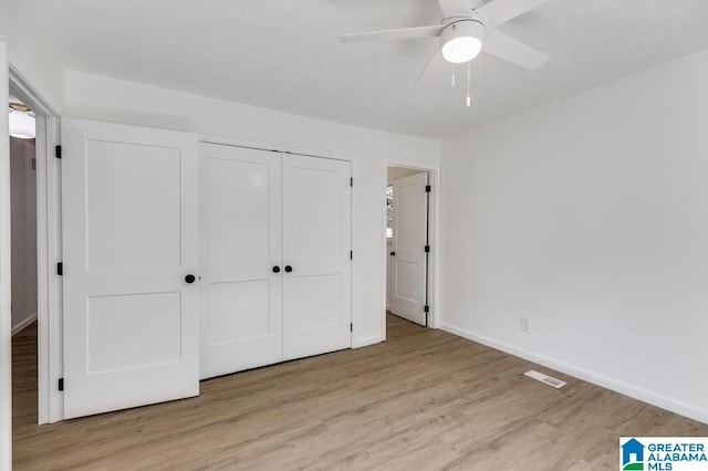 820 Boozer Rd, Heflin, AL 36264 - unfurnished bedroom with wood finished floors, a closet, baseboards, and a ceiling fan