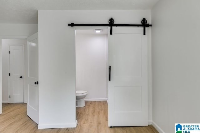 820 Boozer Rd, Heflin, AL 36264 - bathroom with wood finished floors, toilet, and baseboards