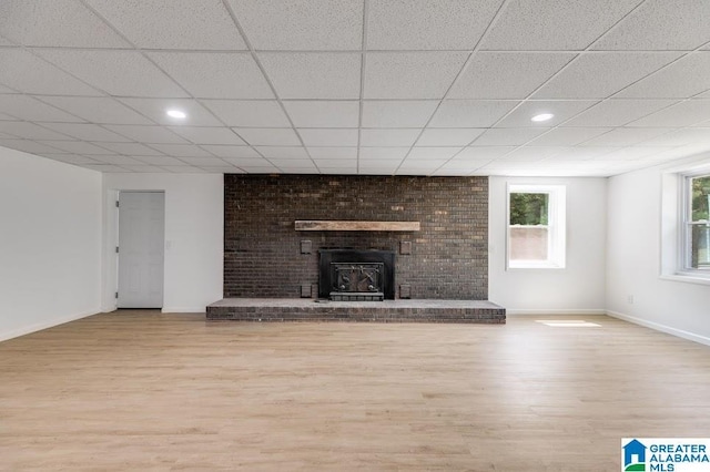 820 Boozer Rd, Heflin, AL 36264 - unfurnished living room with wood finished floors, baseboards, a fireplace, recessed lighting, and a drop ceiling