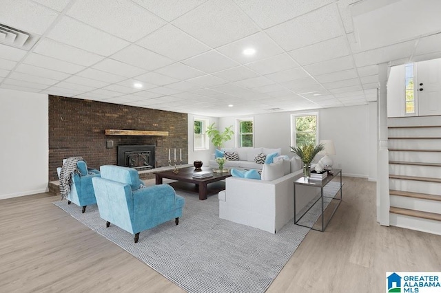 820 Boozer Rd, Heflin, AL 36264 - living area with wood finished floors, a drop ceiling, stairway, and baseboards