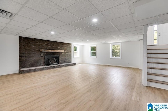 820 Boozer Rd, Heflin, AL 36264 - unfurnished living room featuring baseboards, stairs, wood finished floors, a drop ceiling, and a fireplace