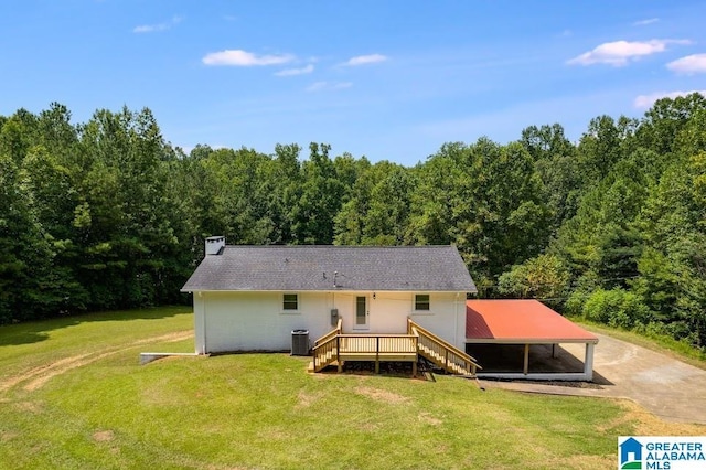 820 Boozer Rd, Heflin, AL 36264 - back of property featuring central AC, a wooded view, a yard, a chimney, and driveway