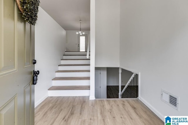 820 Boozer Rd, Heflin, AL 36264 - staircase with wood finished floors, a chandelier, and baseboards