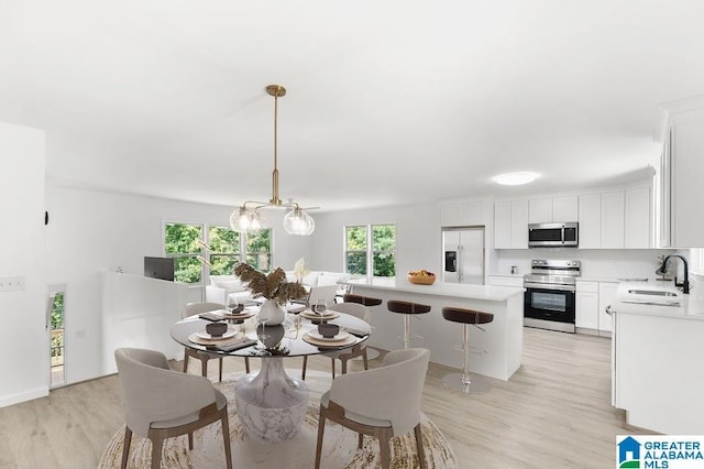 820 Boozer Rd, Heflin, AL 36264 - dining room with light wood-style flooring and a chandelier