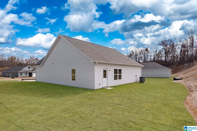 view of side of home with a yard and central AC