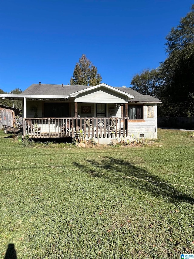 rear view of property with a lawn