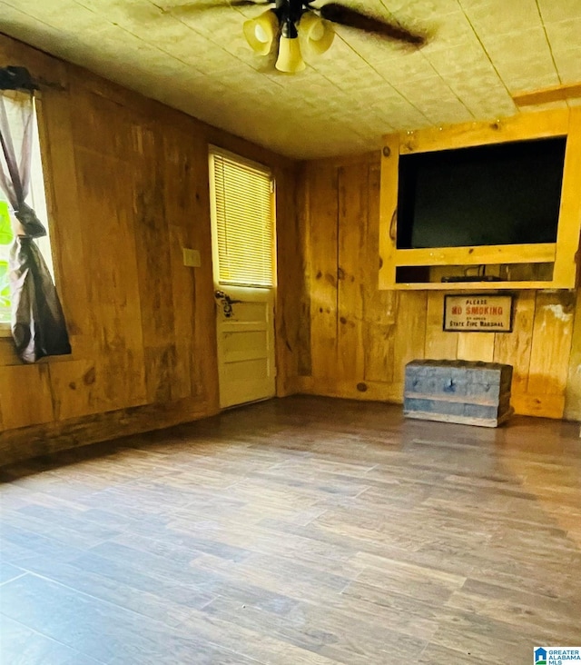 236 Shaw Ln, Sylacauga, AL 35150 - unfurnished living room featuring wooden walls, wood finished floors, and ceiling fan