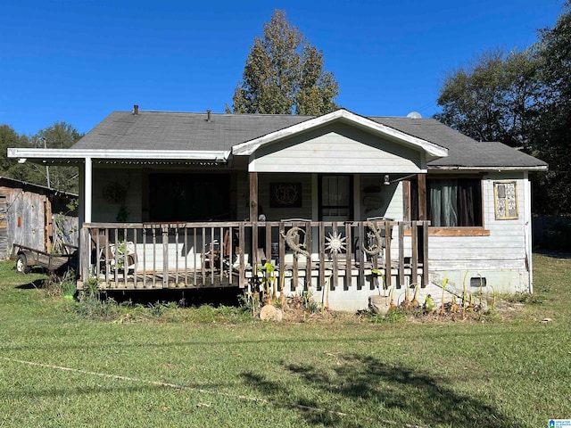 rear view of property with a lawn