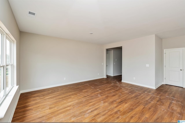 unfurnished room with wood-type flooring