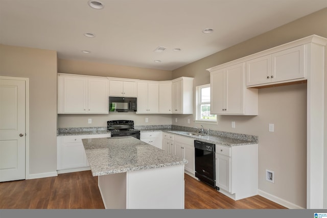 kitchen featuring dark wood-type flooring, black appliances, and white cabinetry