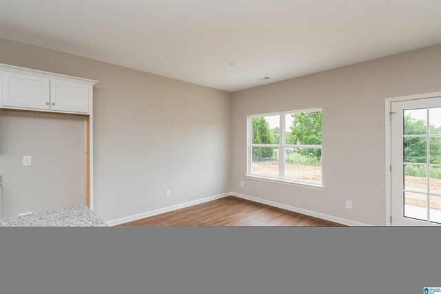 empty room with dark hardwood / wood-style floors