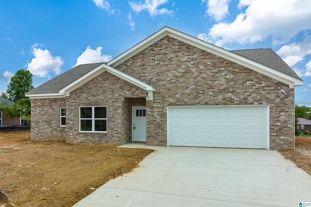 ranch-style house featuring a garage, concrete driveway, brick siding, and a shingled roof