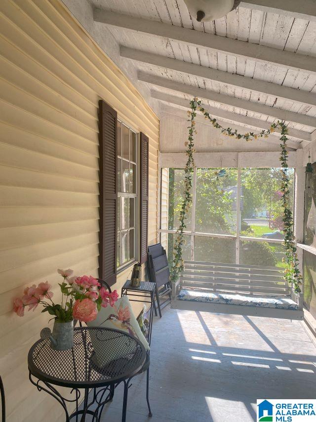 sunroom / solarium with lofted ceiling with beams and wood ceiling