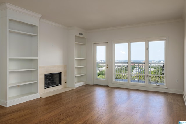 unfurnished living room featuring ornamental molding, a healthy amount of sunlight, hardwood / wood-style floors, and a fireplace