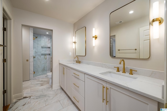 bathroom with vanity, a shower with shower door, and toilet