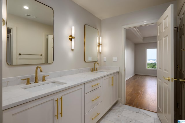 bathroom featuring ornamental molding and vanity