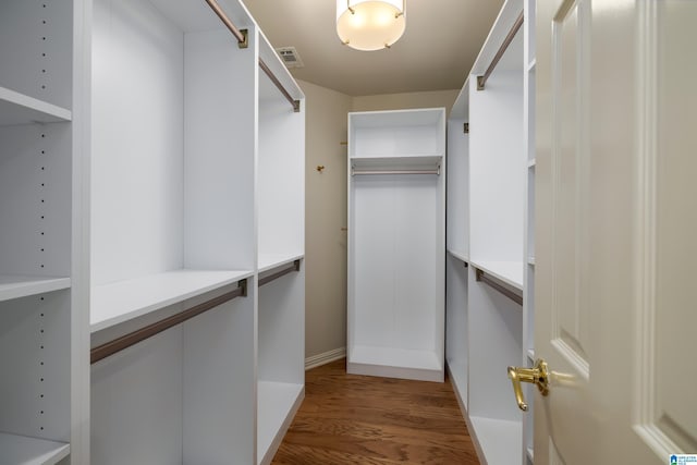 walk in closet featuring dark wood-type flooring