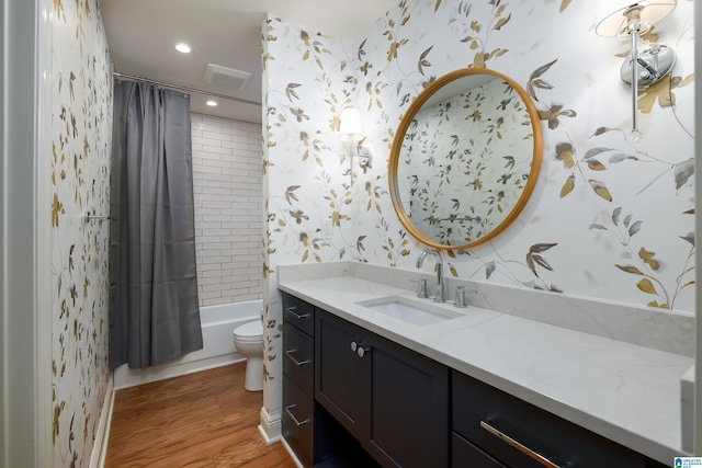 full bathroom featuring shower / tub combo with curtain, vanity, wood-type flooring, and toilet