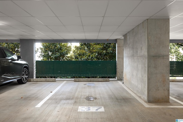 interior space with a wall of windows and a paneled ceiling