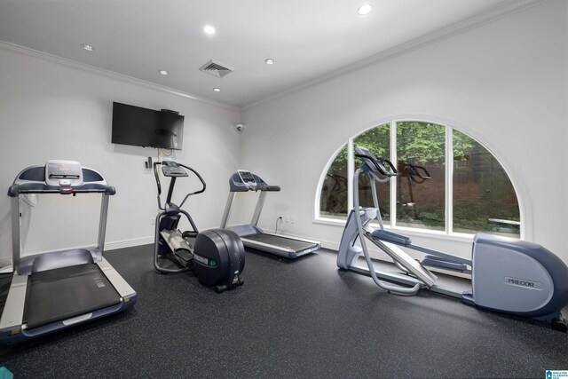 workout room featuring crown molding