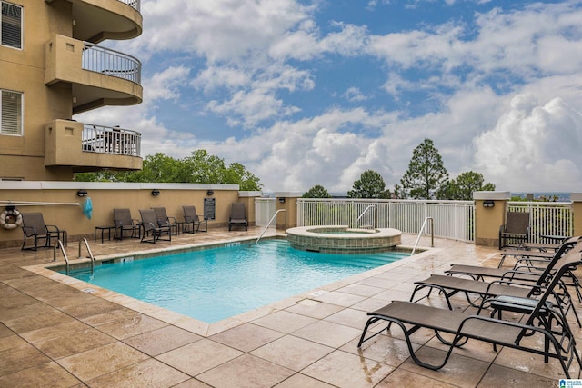 view of pool featuring a patio area and a community hot tub