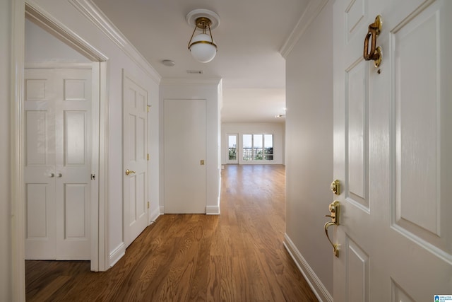 hall featuring crown molding and hardwood / wood-style floors