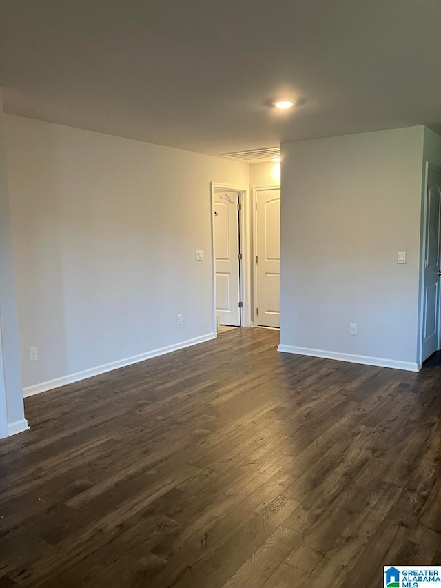 unfurnished room with dark hardwood / wood-style floors