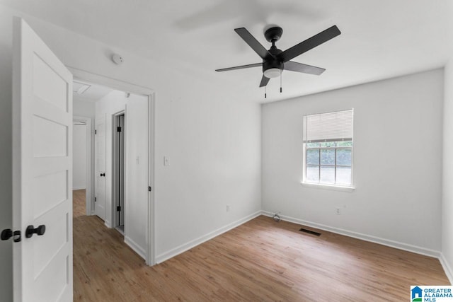 spare room featuring ceiling fan and light hardwood / wood-style flooring