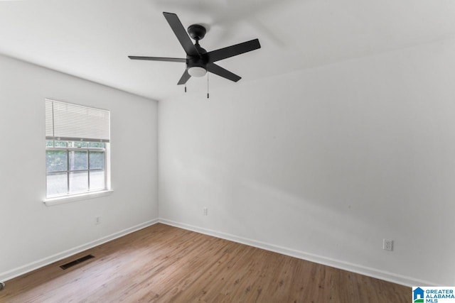 empty room with hardwood / wood-style flooring and ceiling fan