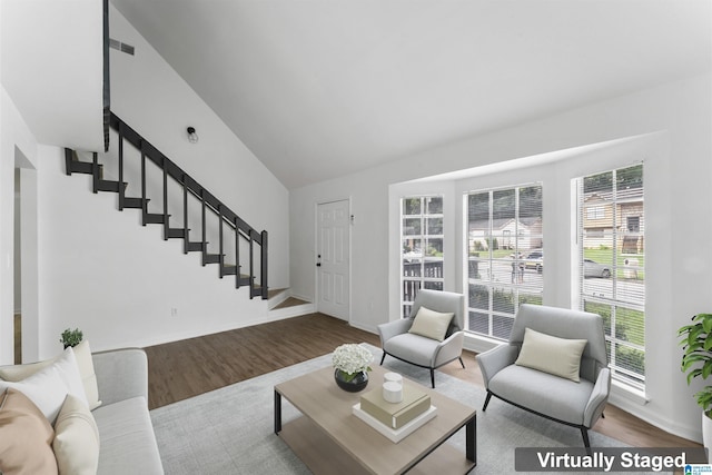 living room featuring hardwood / wood-style flooring and lofted ceiling