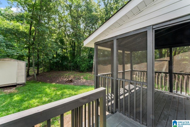 deck featuring a yard and a sunroom