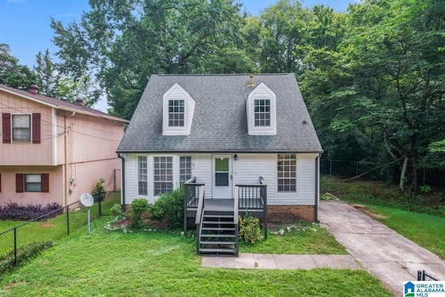 view of front of home with a wooden deck and a front yard