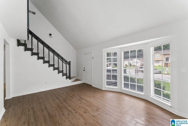 foyer with dark hardwood / wood-style flooring and vaulted ceiling