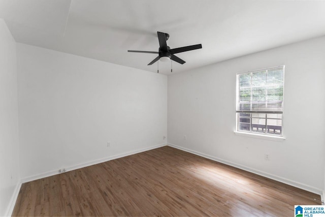 spare room featuring ceiling fan and dark hardwood / wood-style flooring