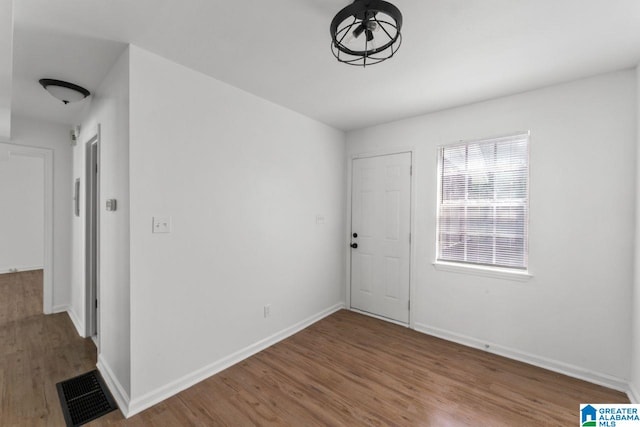 spare room with hardwood / wood-style flooring