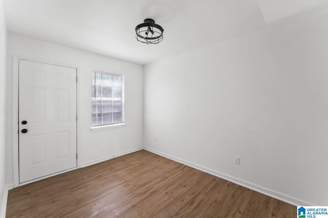 unfurnished room featuring hardwood / wood-style flooring