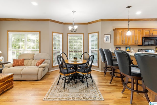 dining room featuring plenty of natural light, a chandelier, and light wood-type flooring