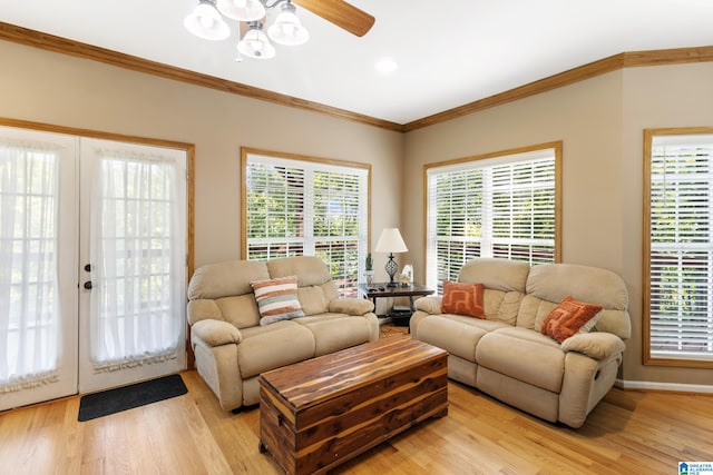 living room featuring light hardwood / wood-style flooring, french doors, crown molding, and ceiling fan