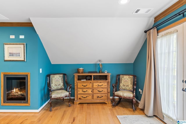 living area with light hardwood / wood-style flooring and vaulted ceiling