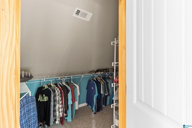 spacious closet featuring lofted ceiling and carpet