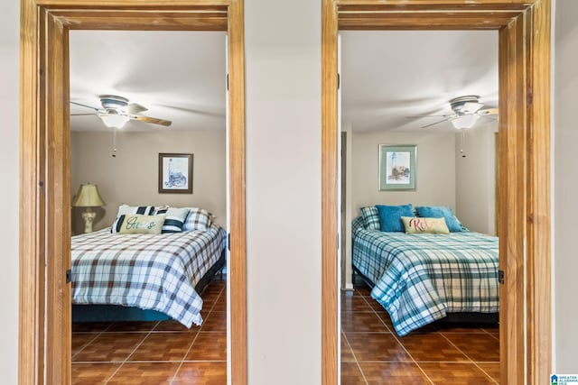 bedroom featuring dark tile patterned flooring and ceiling fan