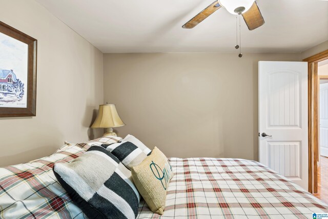 bedroom with ceiling fan and hardwood / wood-style flooring