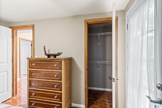 tiled bedroom featuring a closet