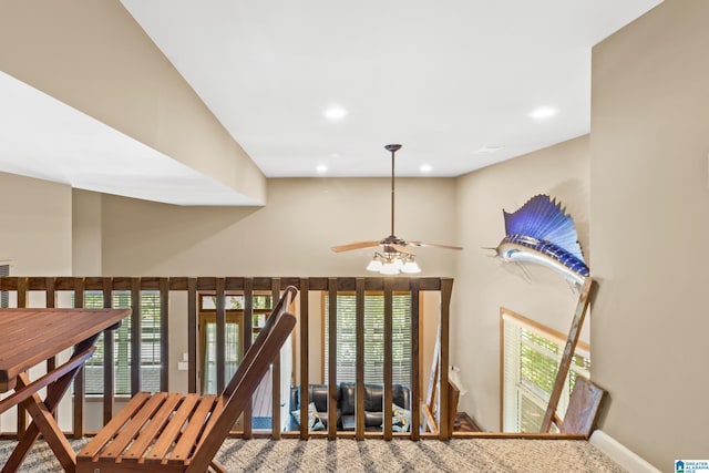 stairs featuring ceiling fan