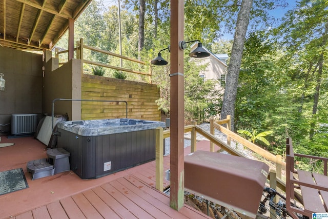 wooden terrace with cooling unit, grilling area, and a hot tub